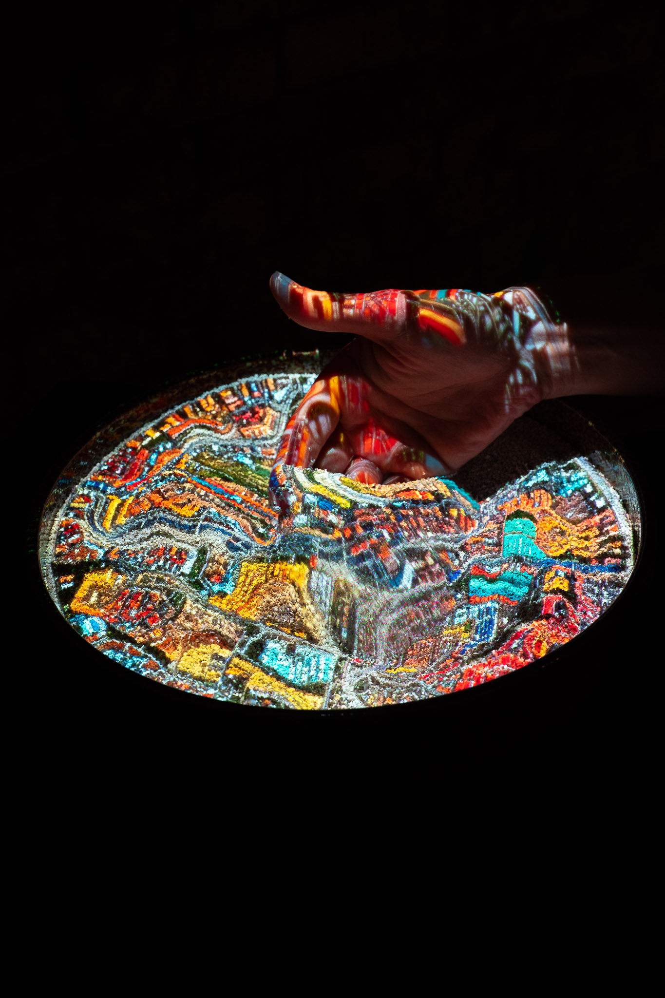 Detail of Experimance installation by Ryan Kelln displaying machine learning generated visuals responding to sand landscape