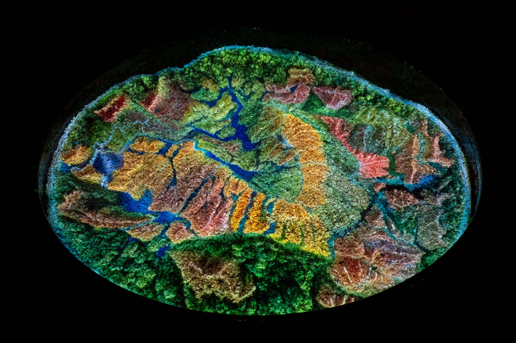 Interactive moment in Experimance by Ryan Kelln where visitor hand movements create AI-powered satellite-like projections